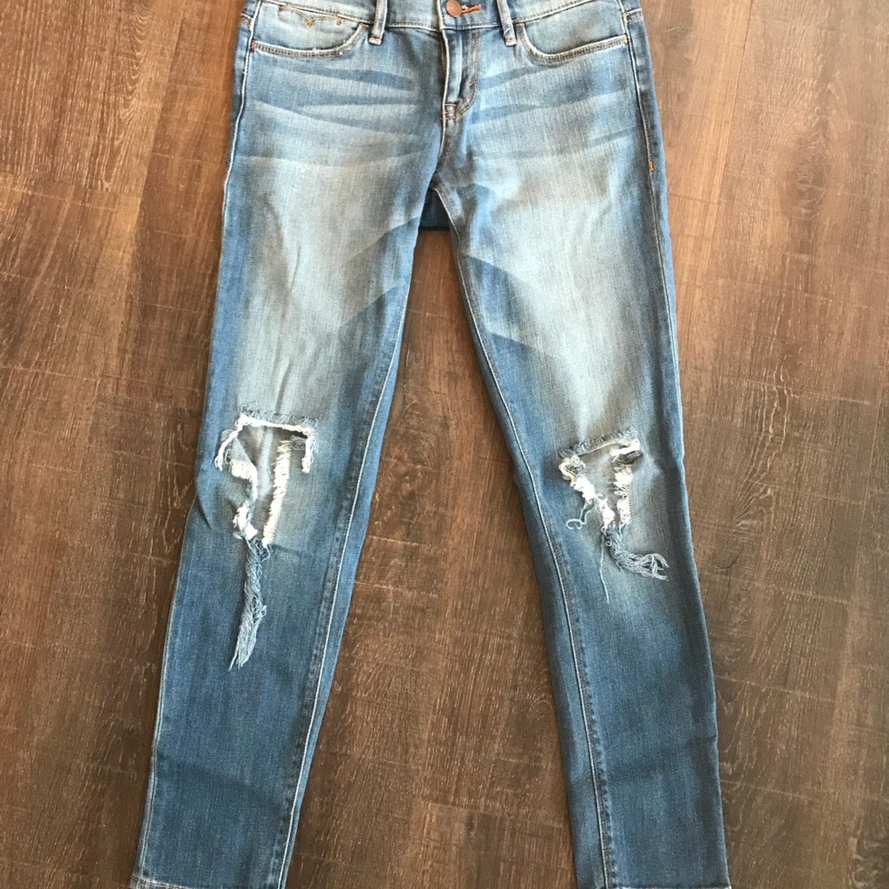 Cropped busted knee skinny jeans